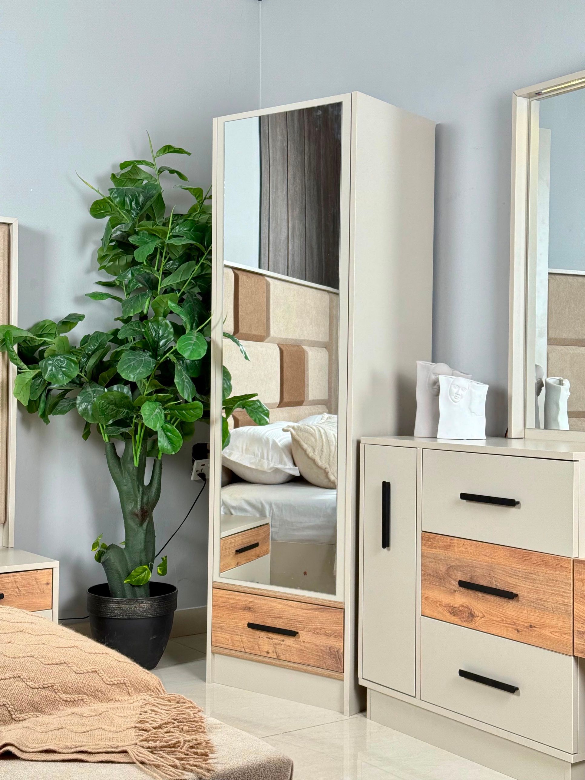Showroomda aynalı bir dolap ve bir şifonyer.